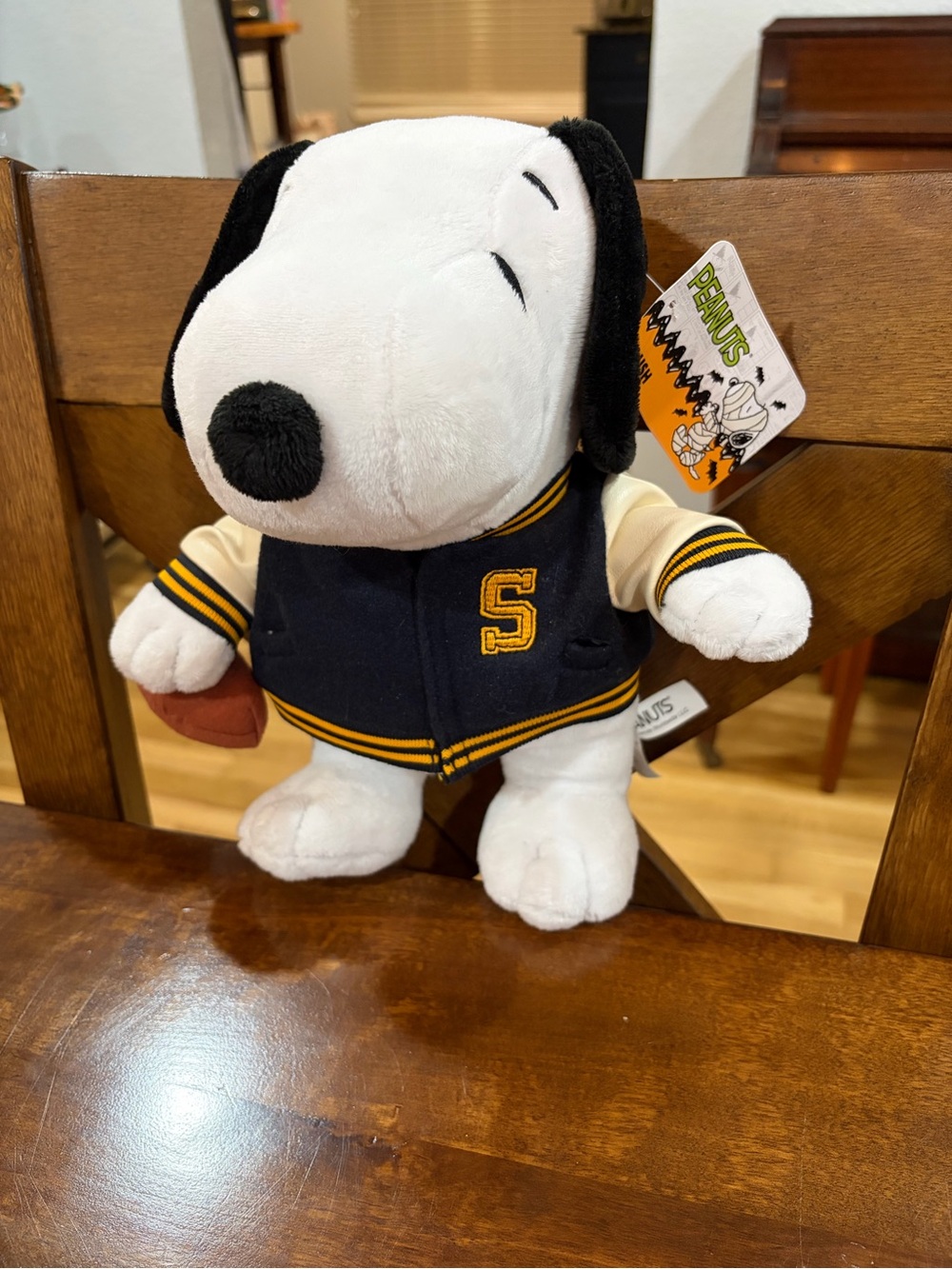 Peanuts Snoopy Plush in Black and White Letterman Jacket with Football - Peanuts